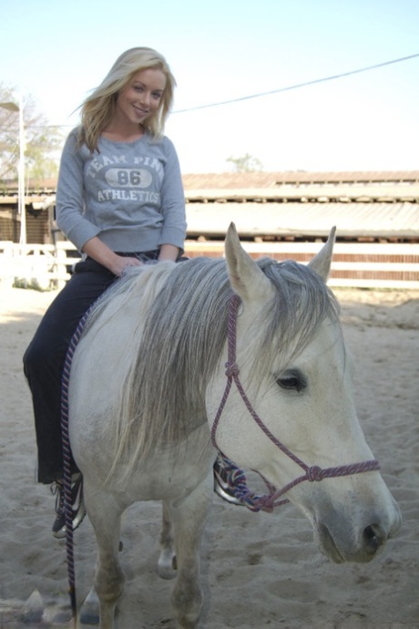 At the ranch, blonde American MILF Kayden Kross enjoys playing with her horse.